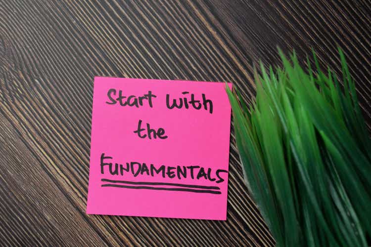 Start With The Fundamentals write on sticky notes isolated on office desk.