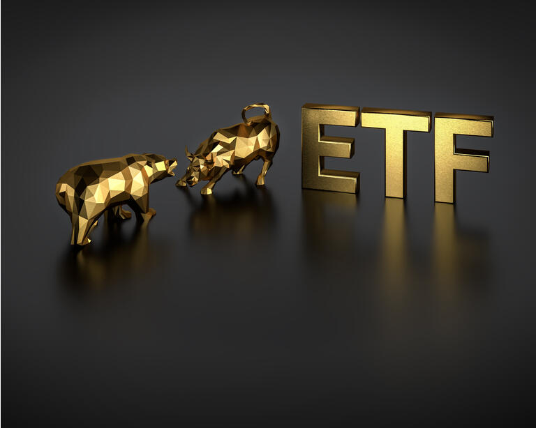 Exchange traded fund concept. A bull and bear besides the golden text ETF.