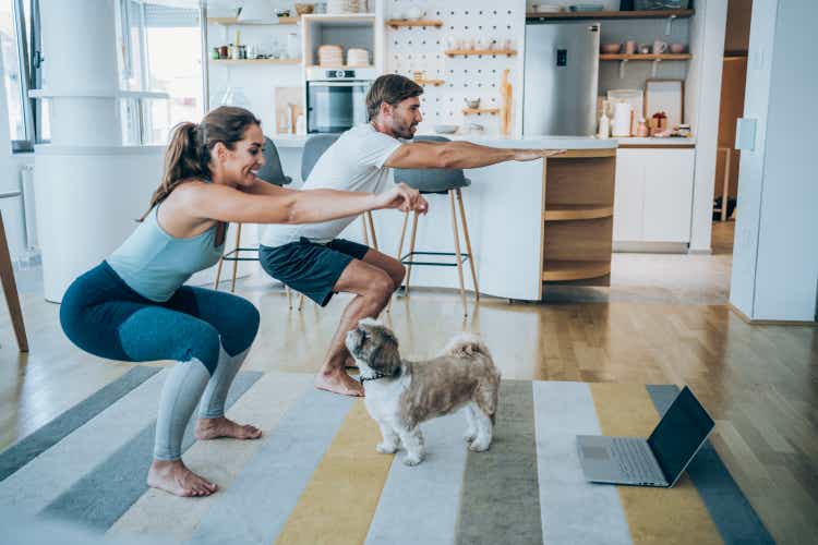 Couple exercising together at home.