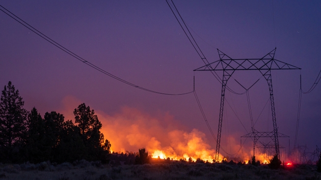 wildfire burns near transmission line