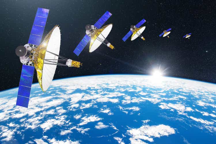 Group of satellites with dish antennas in orbit around the Earth, for communication and monitoring systems. Elements of this image furnished by NASA.
