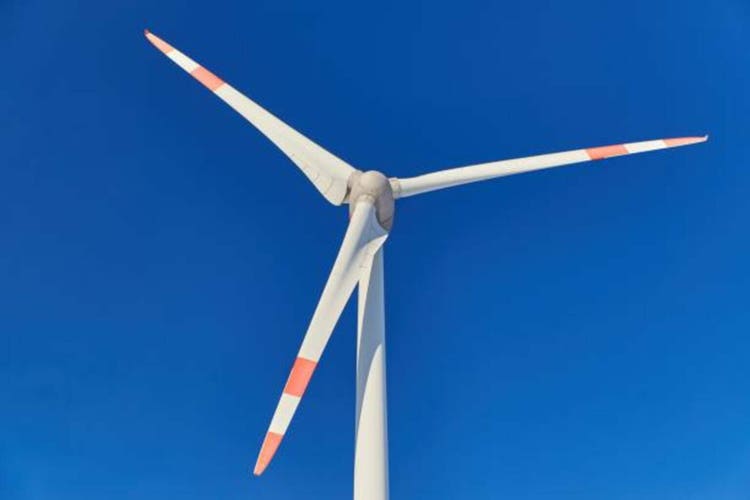 Closeup of a wind turbine nacelle on blue sky. Closeup of a wind power plant on blue sky.
