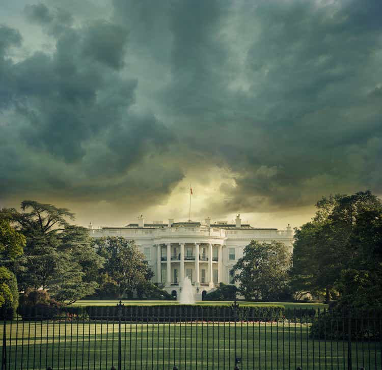 The White House in Washington DC under dark stormy clouds