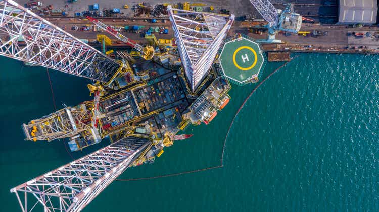 Aerial view maintenance repair of oil and gas platform with jack in shipyard, offshore oil and gas processing platform, oil and gas industry.