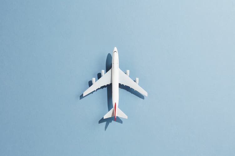 A toy aeroplane against a blue background