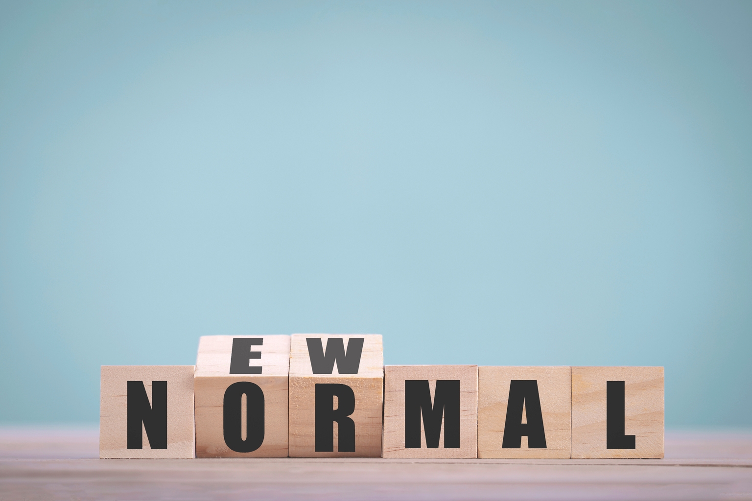 Wooden block cubes flipping for new normal word to changing new lifestyle or business and economy after coronavirus pandemic