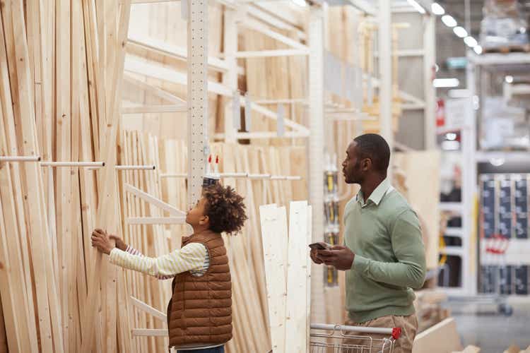 Father and Son Buying Wooden Panels in Construction Store