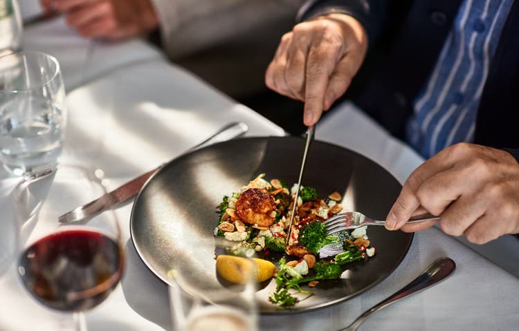 Man eating freshly prepared meal in restaurant