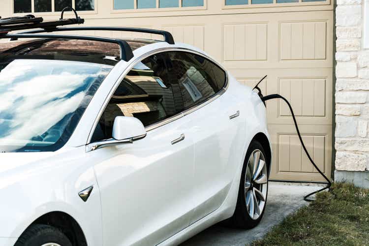 White Tesla Model 3 Charging at Home