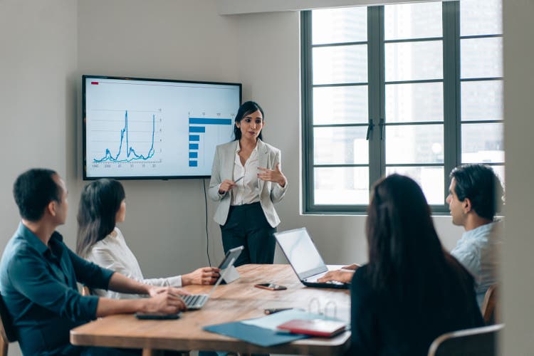 Gender stereotype - Female leadership in a small business meeting