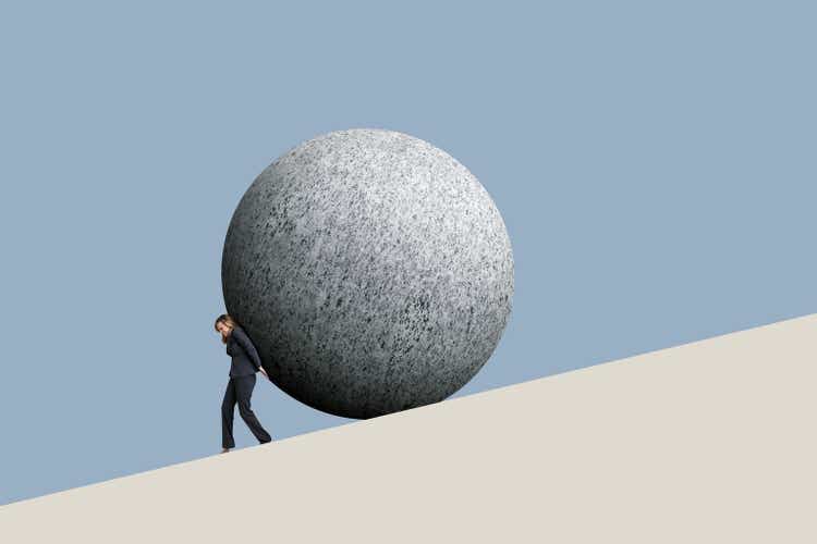 Businesswoman Pushes A Sphere Up A Hill