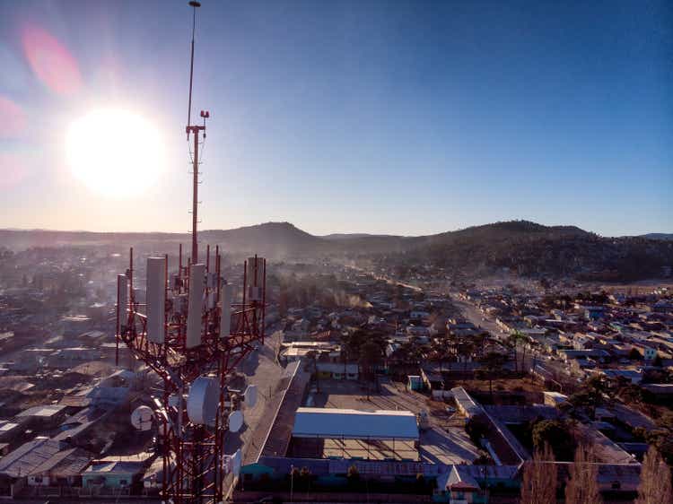 Drone View Of A Communications Cell Tower In San Juanito, Chihuahua, Mexico, In The Sierra Madres, Mountain Town, With The Town Below