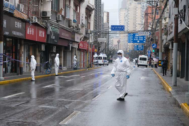 Medical staff in hazmat suit walking on street in Shanghai