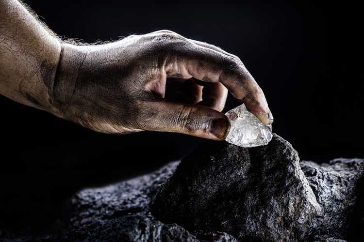 hand removing rare stone from a mine, chinese diamond digging