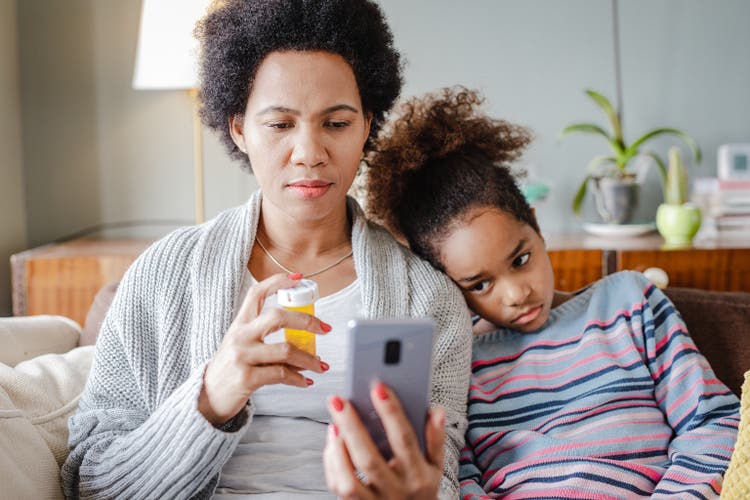 Caring mother communicates with the doctor on a video call