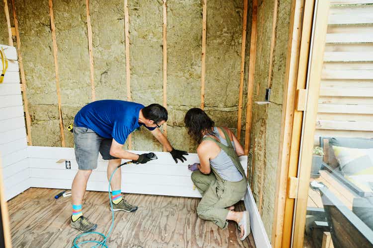 Couple installs siding during home improvement project