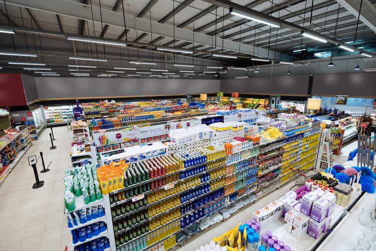 Aisles and shelves in supermarket, wide angle view