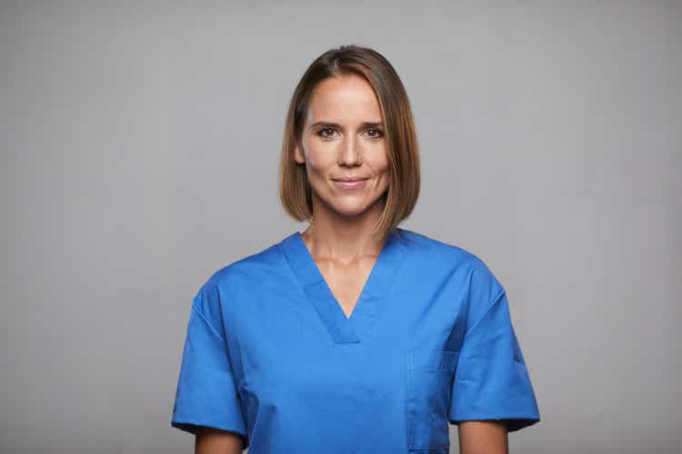 Adult nurse in medical scrubs studio portrait.