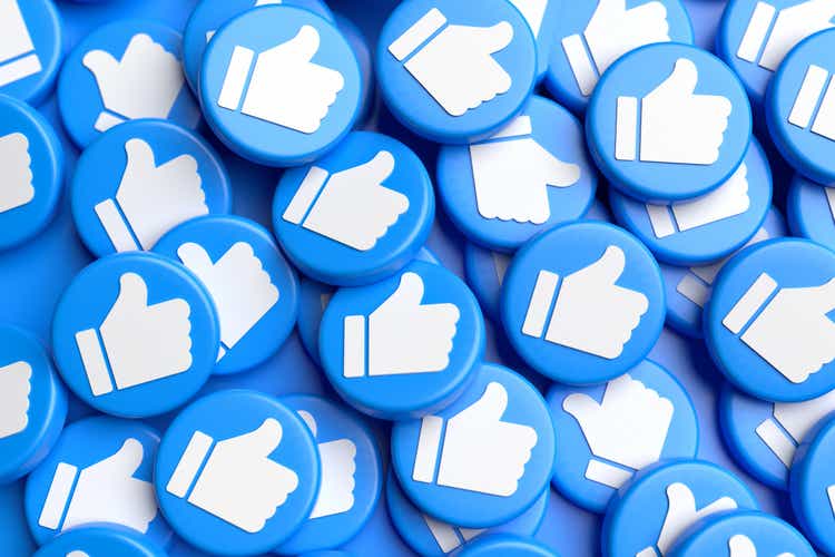 Many like buttons with white thumbs on blue in a pile.  Social media concept.  Full frame.