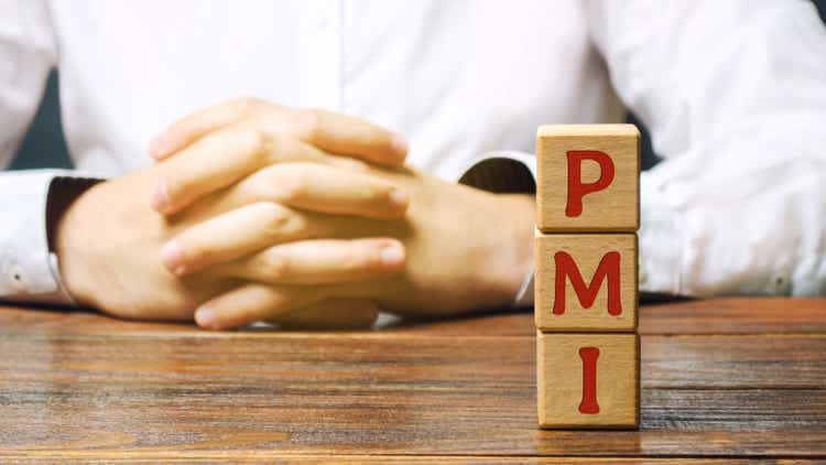 Wooden blocks with the word PMI - Purchasing Managers Index. Economic indicators derived from monthly surveys of private companies. Business assessments and finance concept.