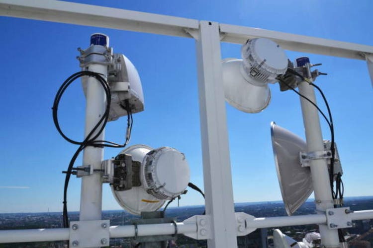 Construction for 5G broadband cellular network transmitters, telecommunication tower, wireless communication concept, clear blue sky background with copy space