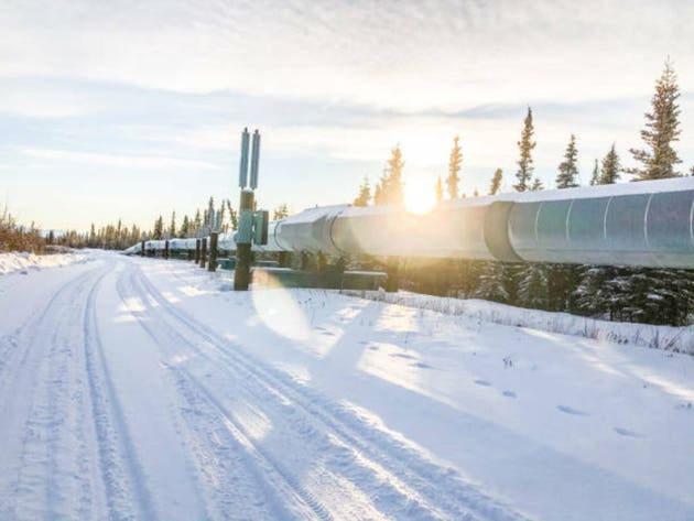 Trans-Alaska Pipeline in Winter With Sunburst