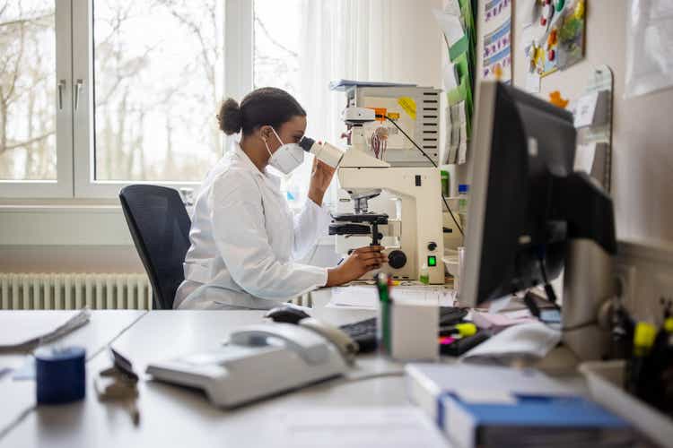 Scientist in the lab using microscope