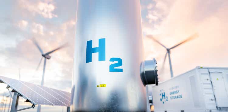 Hydrogen energy storage gas tank with solar panels, wind turbine and energy storage container unit in background. 3d rendering.
