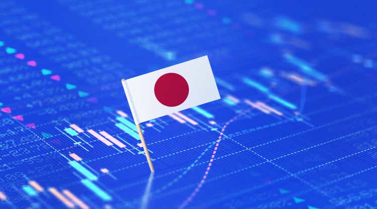 Finance And Stock Market Concept - Japanese Flag Sitting Over Blue Financial Chart