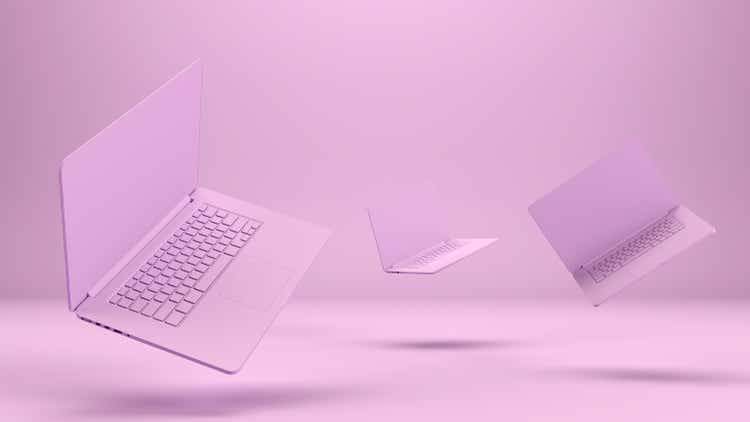 Flying Empty Screen Laptops on Pink Background, Zero Gravity