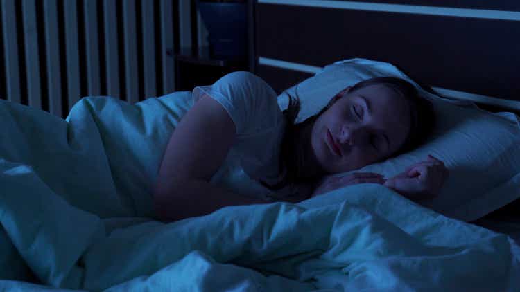 Young woman comfortably sleeping at night in a bed at home. Sleep time