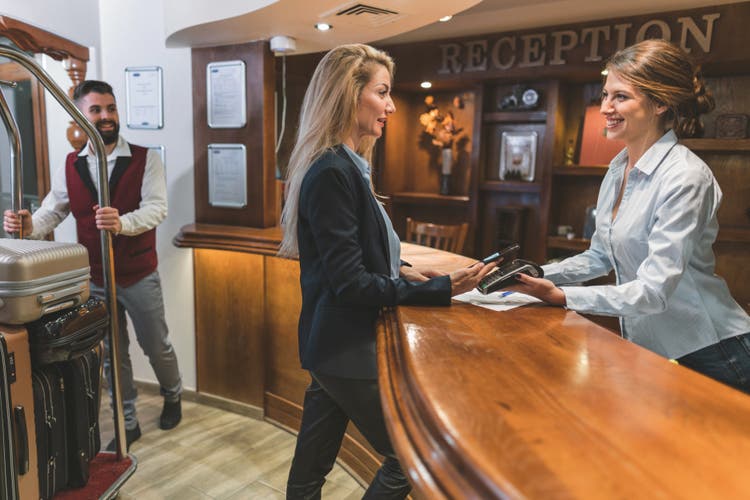 Woman paying with her credit card in the hotel