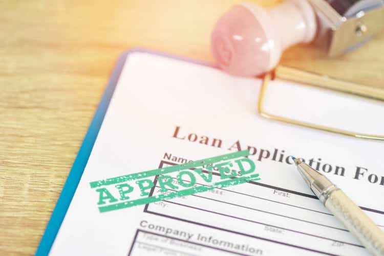 Loan approval, Loan application form with Rubber stamping that says Loan Approved, Financial loan money contract agreement company credit or person.