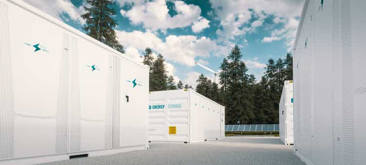 Modern container battery green energy storage system accompanied with solar panels and wind turbine situated in nature 3d rendering.