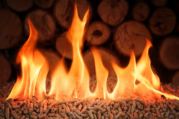 Pile of coniferous pellets in flames - wooden biomass