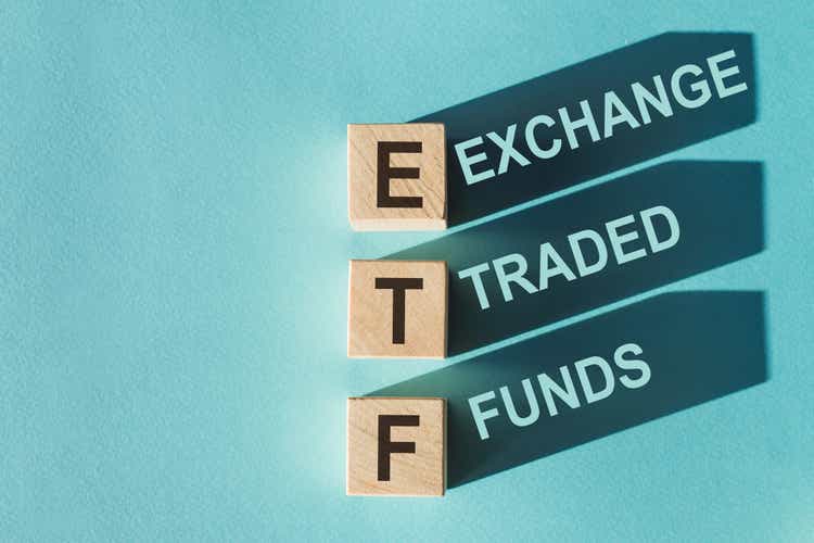 Wood block building from ETF (short for Exchange Traded Fund) on light blue background