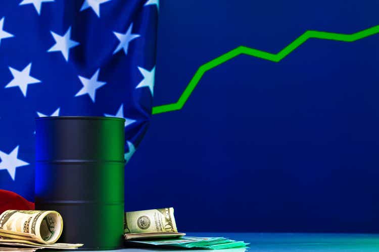 US oil prices are changing concepts.Black barrel with oil and graph
