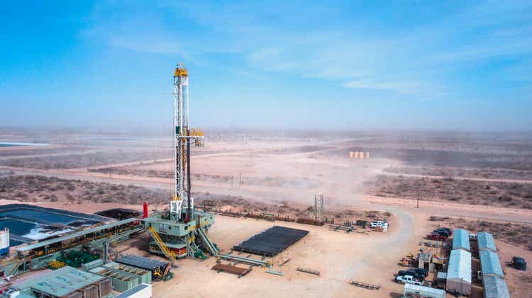 Drone View Of An Oil Or Gas Drill Fracking Rig Pad with Beautiful Cloud Filled Sky