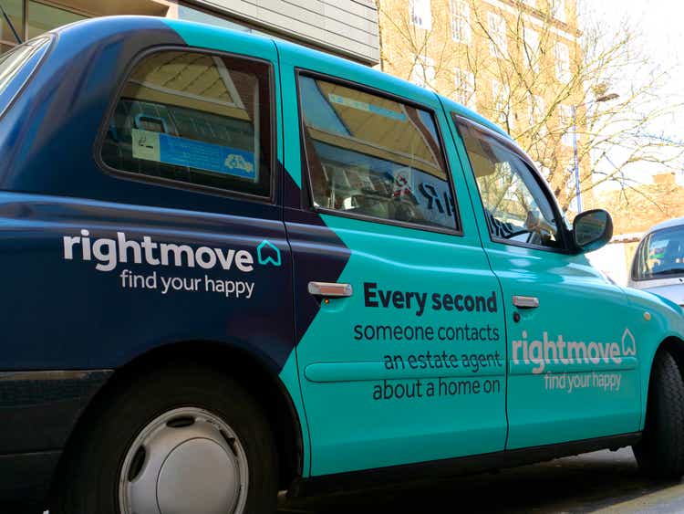 The advertisement of Rightmove painted on the side of a taxi.