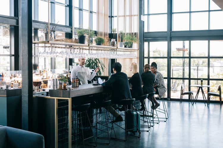 People sitting behind the bar counter