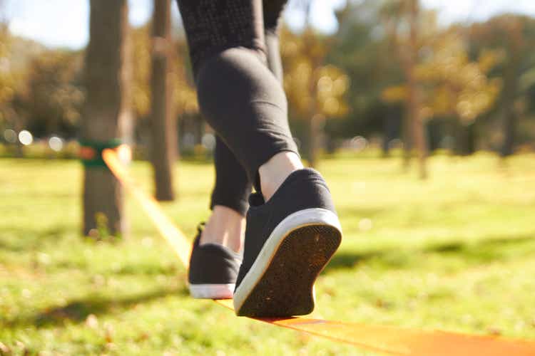 close-up view slacklining feet in springtime at the park