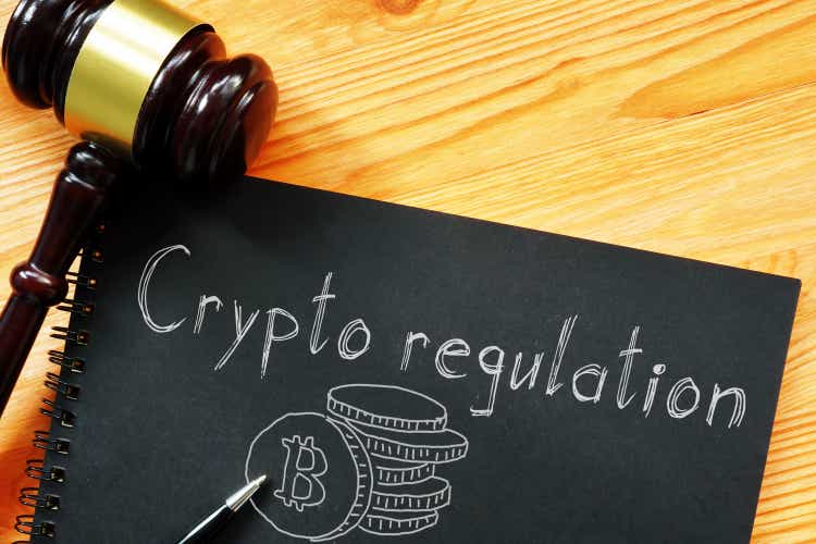 Crypto regulation is shown on the business photo using the text