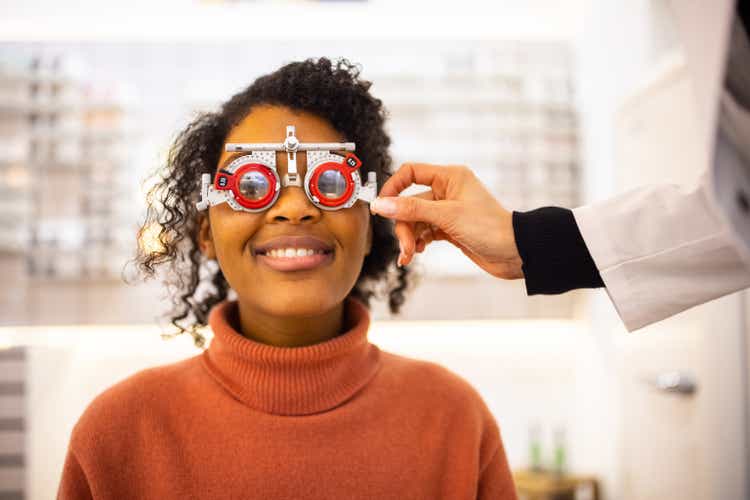 Young woman having eyesight test at optical store