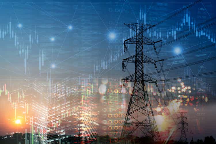 market stock graph and information with city light and electricity and energy facility industry and business background