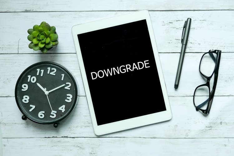 Business concept. Top view of clock,plant,tablet,glasses,pen and tablet written with Tablet on white wooden background.
