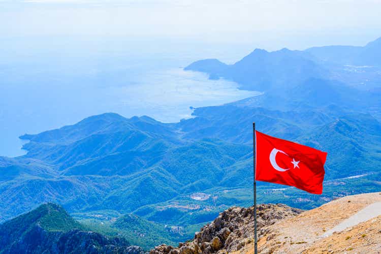 View on Mediterranean sea and hills from the summit of Tahtali mountain. Turkish flag on foreground