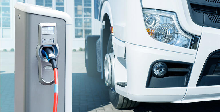 Electric vehicles charging station on a background of a truck