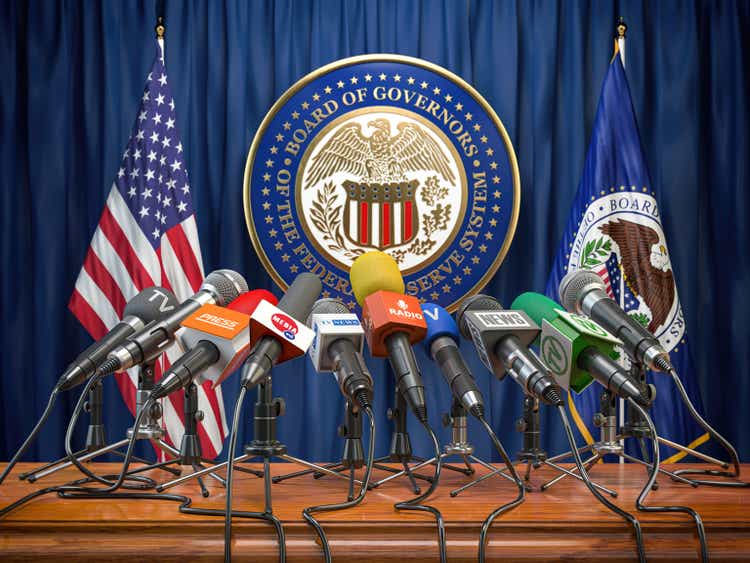 Federal Reserve System Fed of USA press conference concept. Microphones TV and radio channels with symbol and flag of US Federal Reserve. 3d illustration