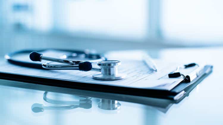 Stethoscope and pen laying on patient information blank