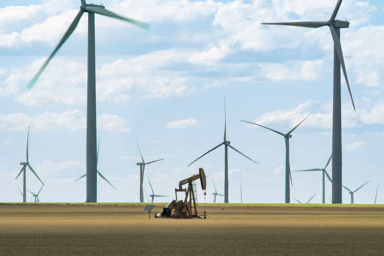 Solo Oil Derrick Stands Among Modern Windmills